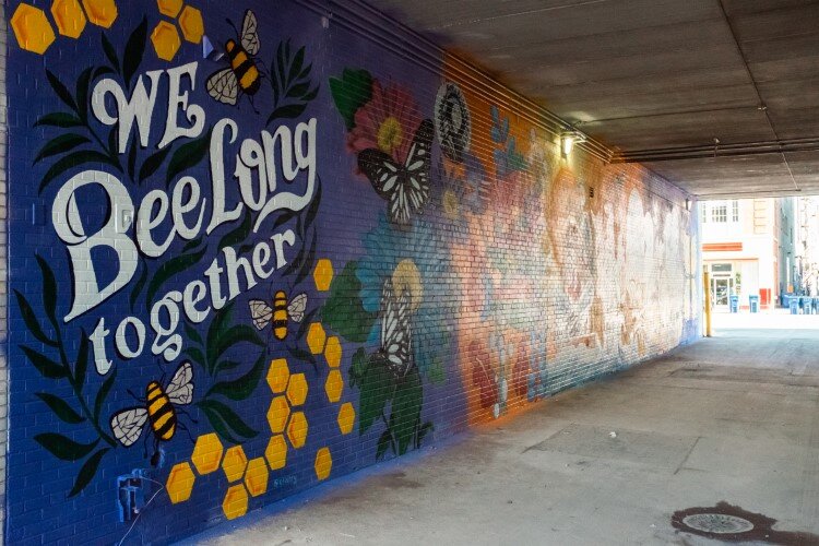 'We Bee-long together,' declares one portion of the mural in the alley.