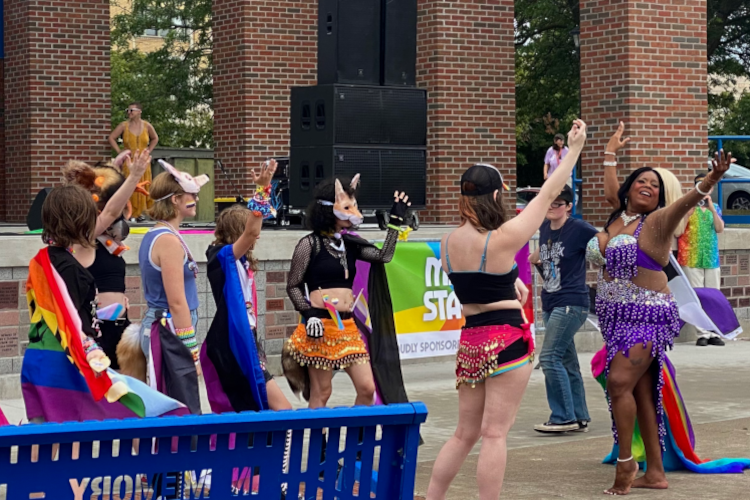 A  performer at the 2024 Great Lakes Bay Pride Festival goes off-stage to teach the crowd some dance moves